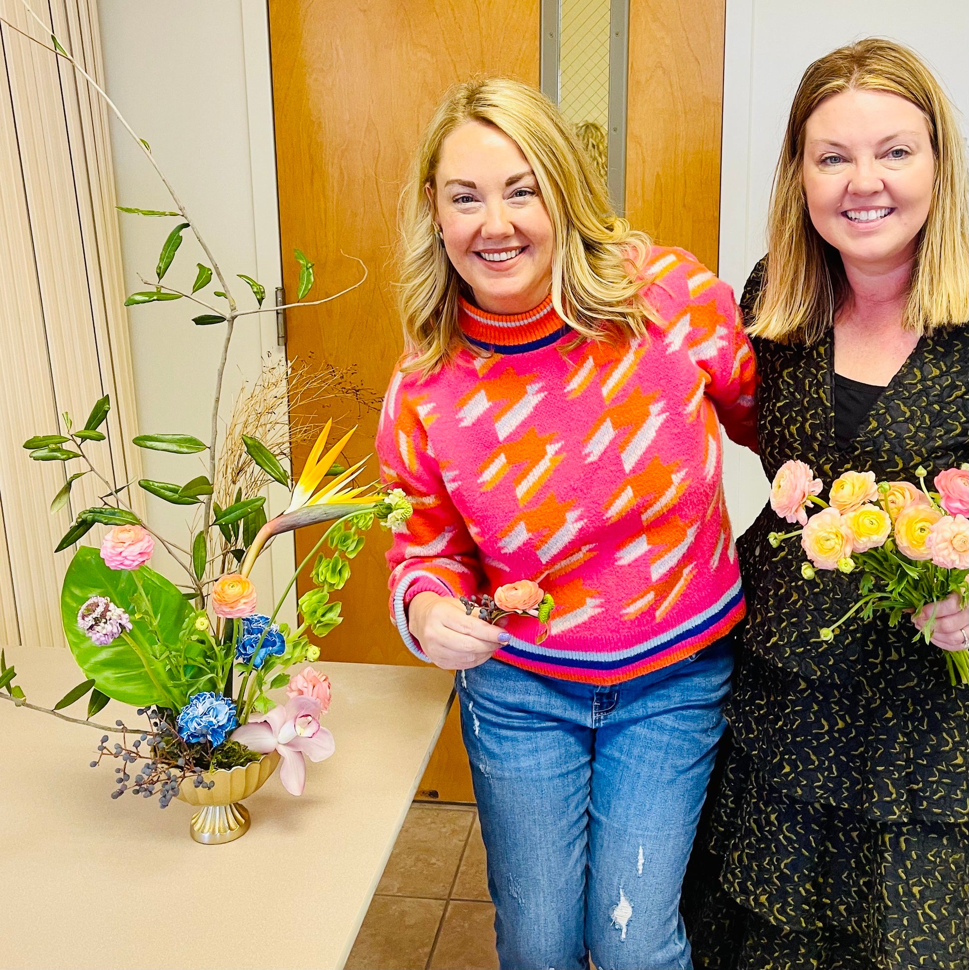 colorful Japanese ikebana floral art design in a gold compote with two women at workshop 